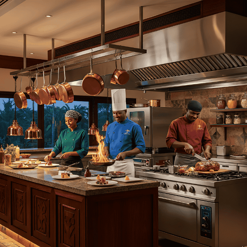 1. Chef Uniforms in Kenya Three chefs in a professional kitchen prepare dishes, while wearing chef coats and chef uniforms in Kenya